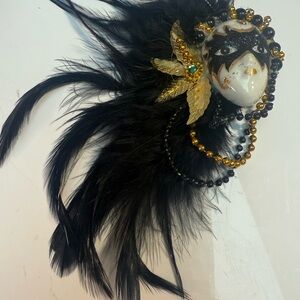 Elegant Black and Gold Feathered Mask magnet.
